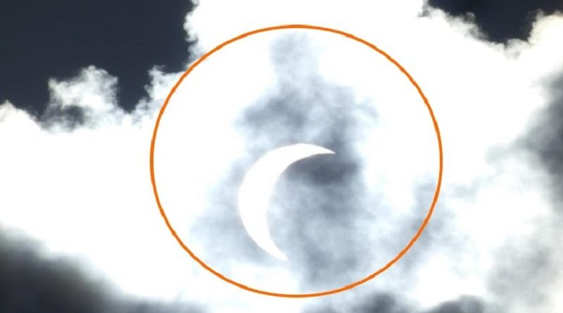 Mysterious Figure In Clouds Behind Eclipse